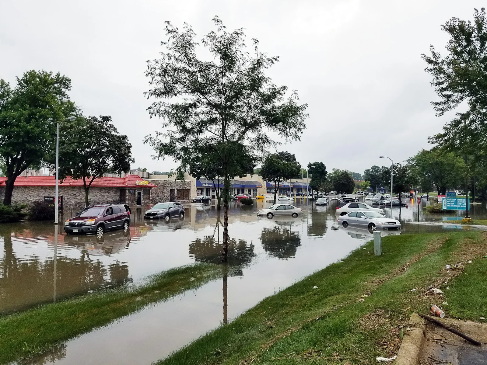 Cars submerged in floodwater on a flooded street
