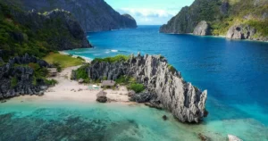 Aerial view of a turquoise lagoon surrounded by limestone cliffs at El Nido, Palawan, Philippines